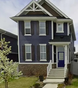 Newly built residential home with blue exterior siding, showcasing fresh construction and modern exterior finishes.