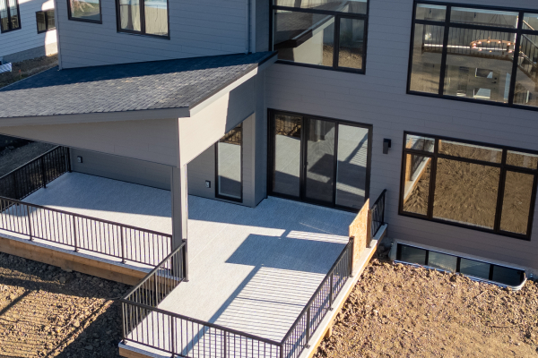 Rear view of modern grey building with clean exterior lines and contemporary architectural styling.